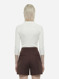 Polo bianca in maglia a micro trecce
